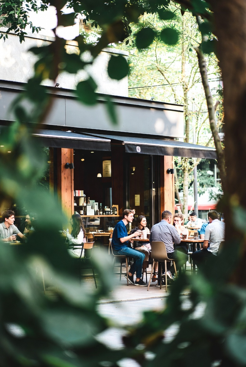 people enjoying coffee in a calm urban cafe atmosphere grok